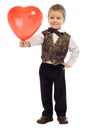 Smiling little boy gives a red balloon Royalty Free Stock Photo