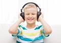 Smiling little boy with headphones at home Royalty Free Stock Photo