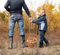 Smiling little boy with his father on the mushrooms picking Royalty Free Stock Photo