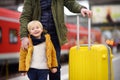 Smiling little boy and his father waiting express train on railway station platform Royalty Free Stock Photo