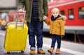 Smiling little boy and his father waiting express train on railway station platform Royalty Free Stock Photo