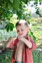 Smiling little boy holding a wriggling worm