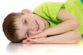 Smiling little boy lying on the floor placing your Royalty Free Stock Photo