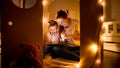 Smiling little boy with mother playing in toy cardboard house and using tablet computer. Concept of child education and Royalty Free Stock Photo