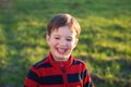 A smiling little boy outdoors Royalty Free Stock Photo