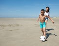 Smiling little boy playing with ball on beach Royalty Free Stock Photo