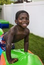 Smiling little boy playing outdoors on an inflatable bounce house