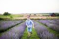 Smiling little boy running on the lavender field. Funny child in sunglasses dressed in a blue shirt and a straw hat running on a g Royalty Free Stock Photo