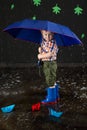 Smiling little boy sheltering from water beneath