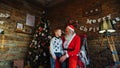 Little boy runs to Santa and puts desire on Santa s ear.r Royalty Free Stock Photo