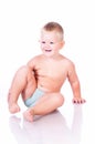 Smiling little boy sitting on the floor. Royalty Free Stock Photo