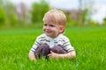 Smiling little boy sitting in fresh grass Royalty Free Stock Photo