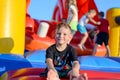 Smiling little boy sitting on a jumping castle Royalty Free Stock Photo