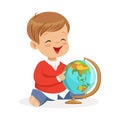 Smiling little boy sitting and playing with globe. Child learning the world colorful cartoon character vector
