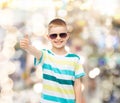 Smiling little boy in sunglasses showing thumbs up Royalty Free Stock Photo