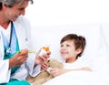 Smiling little boy taking cough medicine Royalty Free Stock Photo