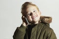 Smiling little boy talking on the cellphone. happy child in winter coat. fashion kids.children Royalty Free Stock Photo