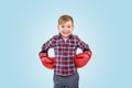 Smiling little boy wearing boxing gloves and looking at camera Royalty Free Stock Photo