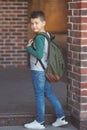 Smiling little boy 6-7 years old goes to school in casual clothes and backpack Royalty Free Stock Photo