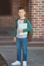 Smiling little boy 6-7 years old goes to school in casual clothes and backpack Royalty Free Stock Photo