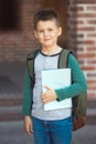 Smiling little boy 6-7 years old goes to school in casual clothes and backpack Royalty Free Stock Photo