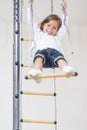 Smiling Little Caucasian Girl Having Exercises on Wall Bars Royalty Free Stock Photo