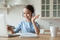 Little girl have video call on laptop at home