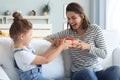 Smiling little child congratulate give gift box to happy mother