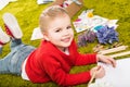 smiling  little child drawing with color pencils on green Royalty Free Stock Photo