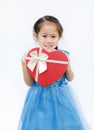 Smiling little child girl with red heart gift box isolated on white background. Concept Valentine`s Day Royalty Free Stock Photo