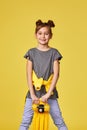 smiling little child girl with yellow skateboard Royalty Free Stock Photo