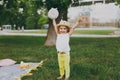 Smiling little cute child baby girl with basket play and have fun, spreading hands on green grass lawn in park. Mother Royalty Free Stock Photo