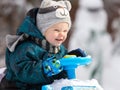 Smiling little driver holds steering wheel of his toy car Royalty Free Stock Photo