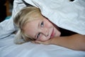 Smiling little girl in the bed under cover Royalty Free Stock Photo