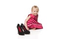 Smiling little girl with big shoes Royalty Free Stock Photo