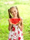 Smiling little girl with blue eyes eats a slice of watermelon Royalty Free Stock Photo