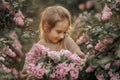 Smiling little girl with bouquet of lilac flowers Royalty Free Stock Photo