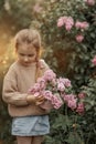 Smiling little girl with bouquet of lilac flowers Royalty Free Stock Photo