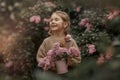 Smiling little girl with bouquet of lilac flowers Royalty Free Stock Photo