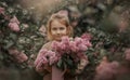 Smiling little girl with bouquet of lilac flowers Royalty Free Stock Photo