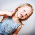 Smiling little girl brushing her hair. Royalty Free Stock Photo