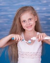 Smiling little girl brushing her teeth in the bathroom Royalty Free Stock Photo