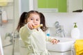 Smiling little girl brushing teeth in bath Royalty Free Stock Photo