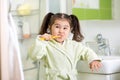 Smiling little girl brushing teeth in bathroom Royalty Free Stock Photo