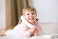 Smiling little girl on carpet with phone Royalty Free Stock Photo