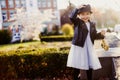 Smiling little girl with a cat hat walking in the city in sunny weather Royalty Free Stock Photo