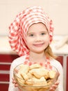 Smiling little girl in chef hat holding bowl Royalty Free Stock Photo