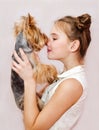 Smiling little girl child schoolgirl holding and playing with pet dog yorkshire terrier Royalty Free Stock Photo