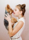 Smiling little girl child schoolgirl holding and playing with pet dog yorkshire terrier Royalty Free Stock Photo