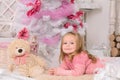 Smiling little girl at christmas tree indoors Royalty Free Stock Photo